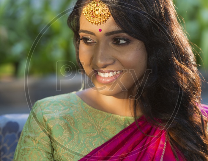 Indian  smiling Female Model in Saree with Jewellery