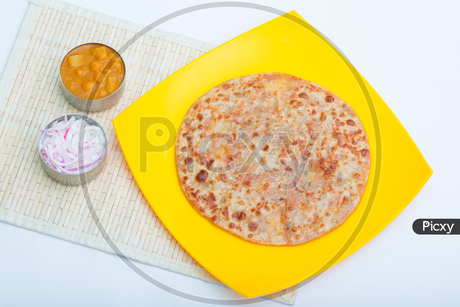 Indian Paratha / Roti in a Plate Composition Shot with White Background