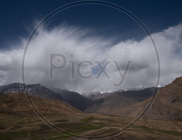 A Beautiful Scenic Views Of leh /Ladakh  with Barn Green Fields and  Sand Dunes and Mountains with Beautiful sky
