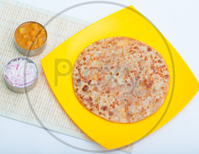 Indian Paratha / Roti in a Plate Composition Shot with White Background
