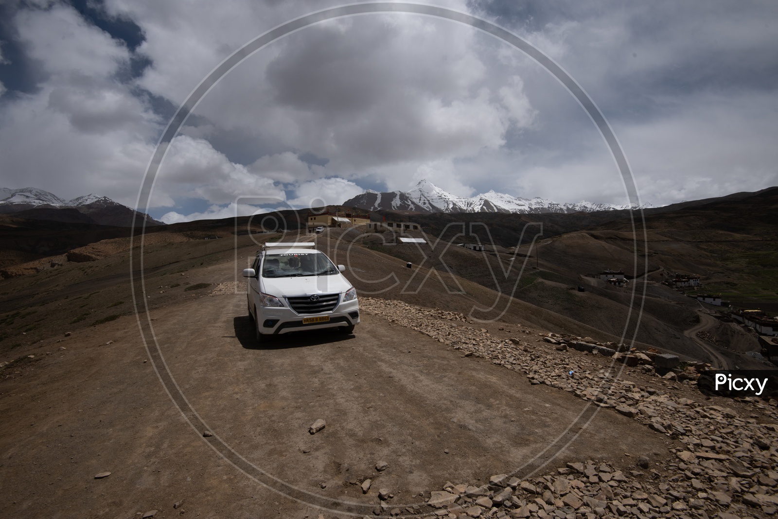 A Car in the Roads of Leh / Ladakh with  Mountains in Backdrop