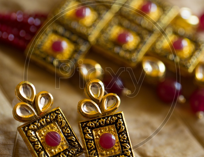 Indian Traditionally Made Designs For Bridal Collection of Gold Jewellery Necklace and Ear Rings Set Closeup Shot