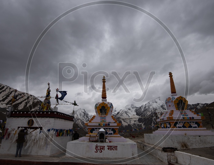 Tibetan Temple Stupas  with Colorful tibetan Flags  with Mountains in Background