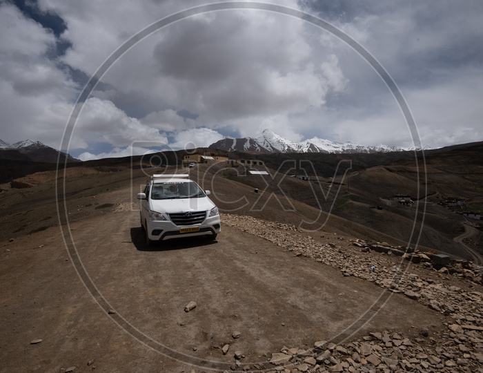 A Car in the Roads of Leh / Ladakh with  Mountains in Backdrop
