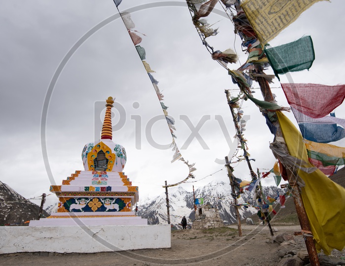 Tibetan Temple Stupas  with Colorful tibetan Flags  with Mountains in Background