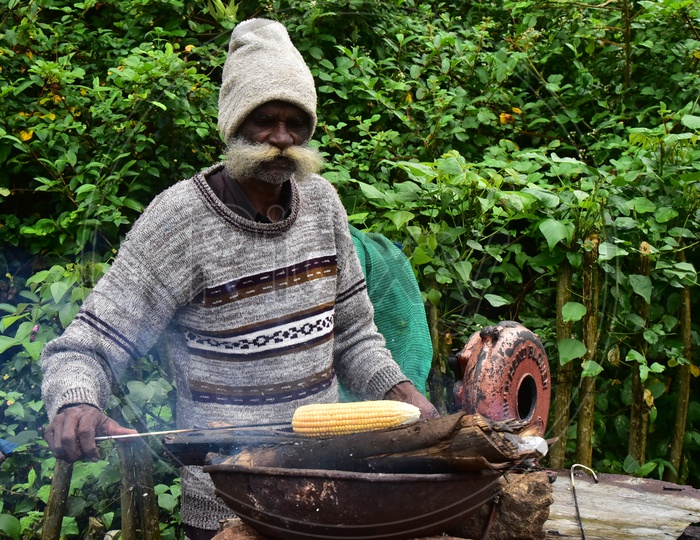 Old man Selling Corn in Munnar Tea Plantations