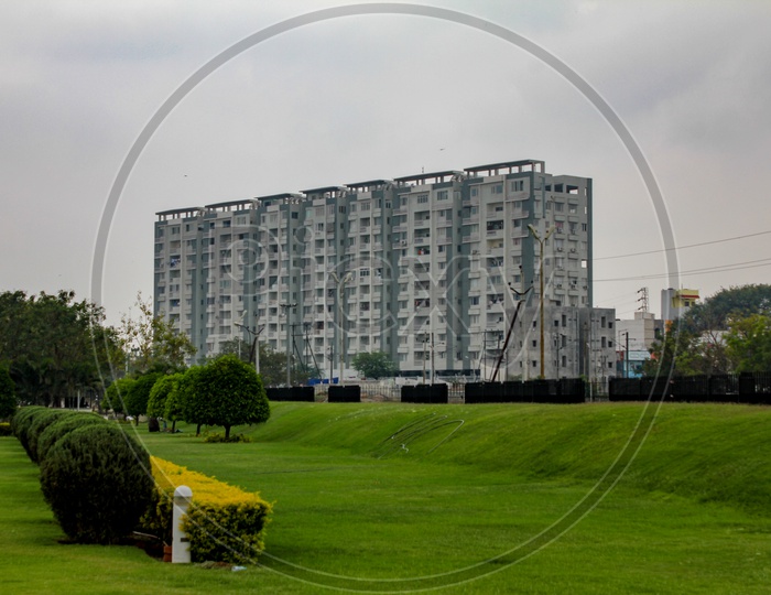 A Beautiful View of Apartments and Garden With green Grass