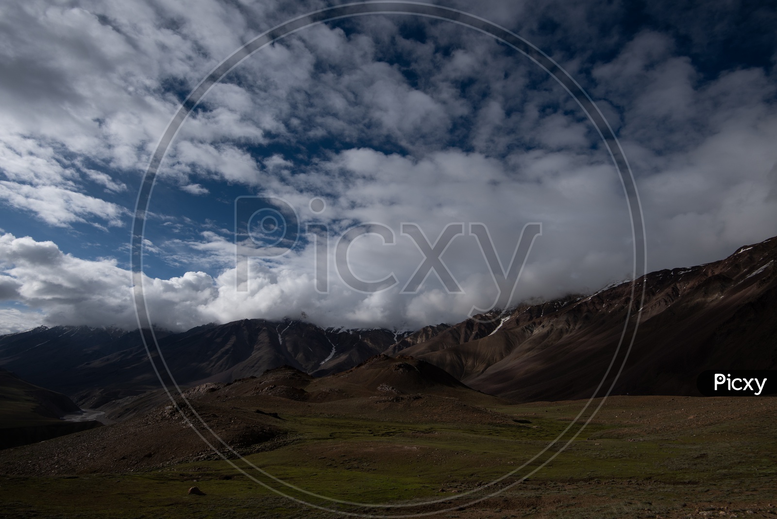 Valleys In Leh / Ladakh With Mountains In Background and Clouds in Sky