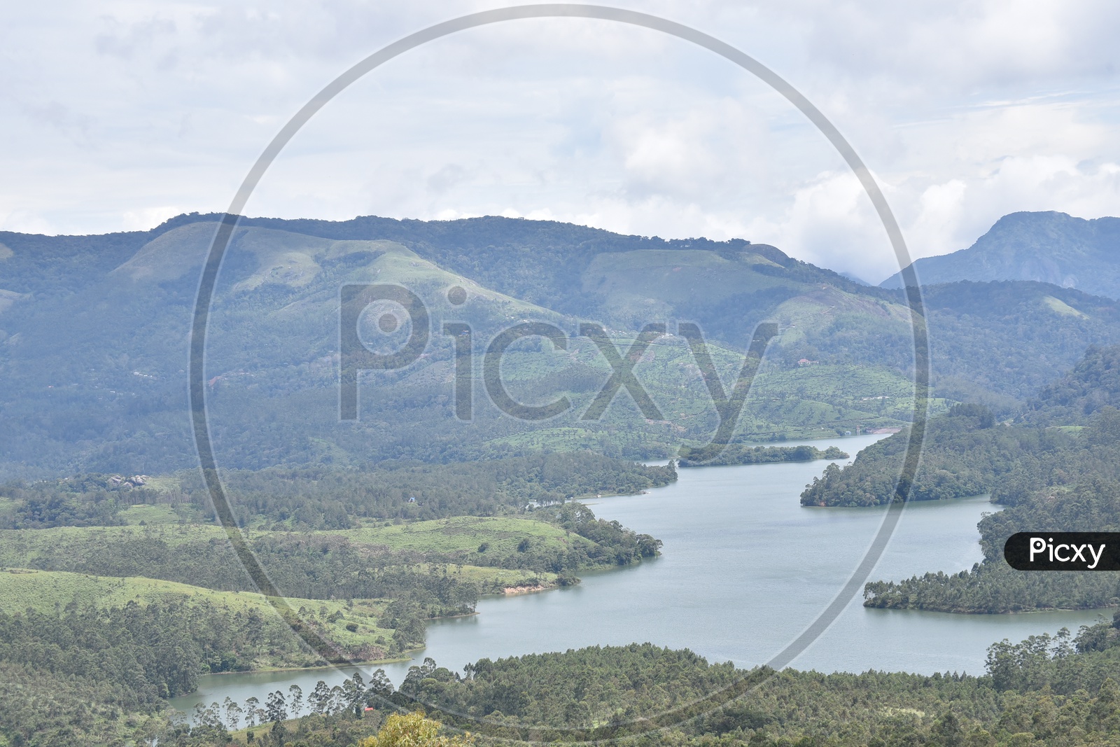 Landscape of Munnar mountains and lake flowing from the center