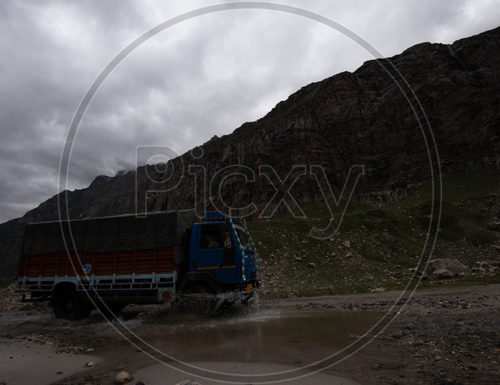 A Transport Vehicle Crossing a Water Pit On Roads Of Leh / Ladakh