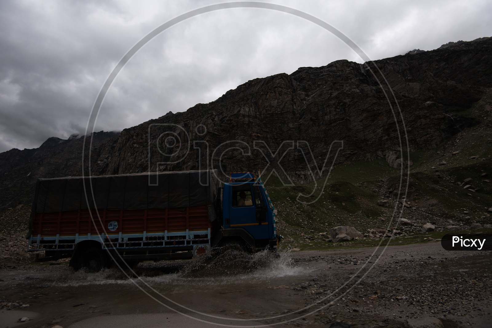 A Vehicle Crossing  a Water Pit On Road Of  Leh / Ladakh