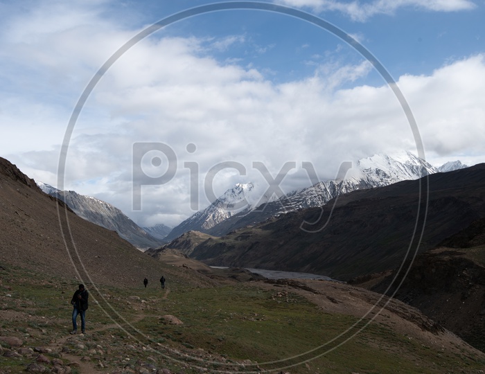 Photographers in Valleys of  Leh / Ladakh With Mountains,  Dunes and Sky With Clouds As a Backdrop