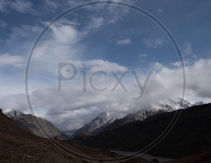 River valleys in Leh / Ladakh With Mountains,  Dunes and Sky With Clouds As a Backdrop