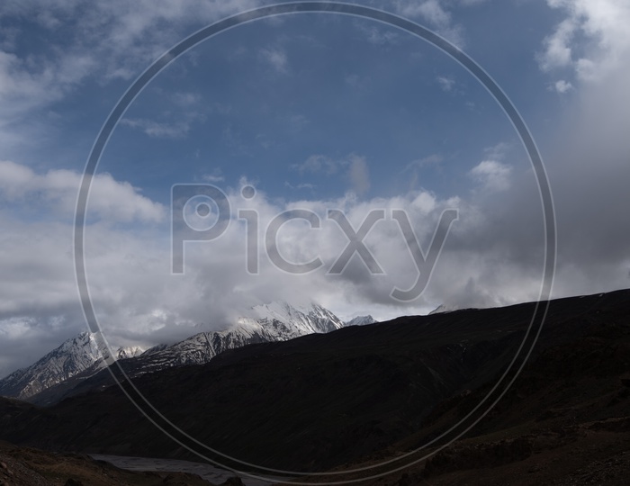 River valleys in Leh / Ladakh With Mountains,  Dunes and Sky With Clouds As a Backdrop