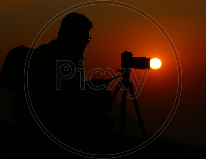 Silhouette Of a Photographer Over a Sunset