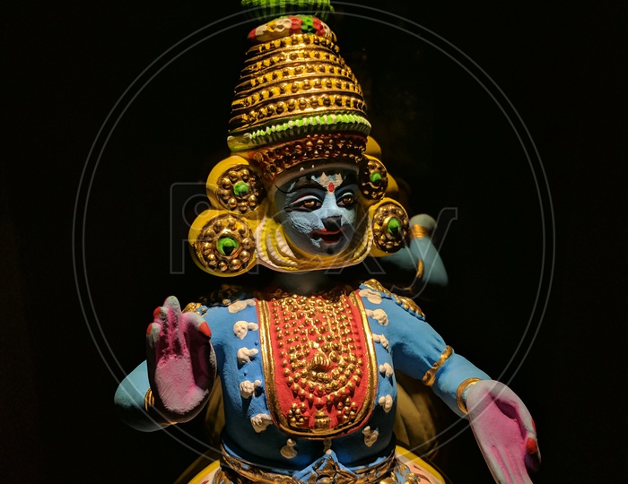 Beautiful Clay Doll of South Indian Dancing Icon with a Black Background