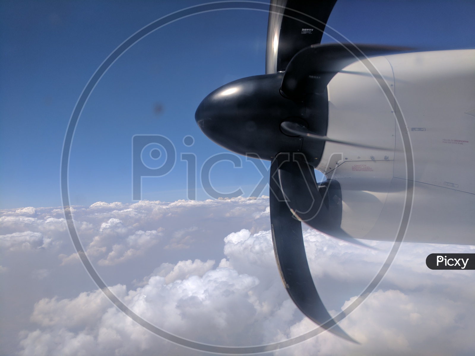 Flight Propellers Shot from Window Of a Plane With Clouds and Sky In Background