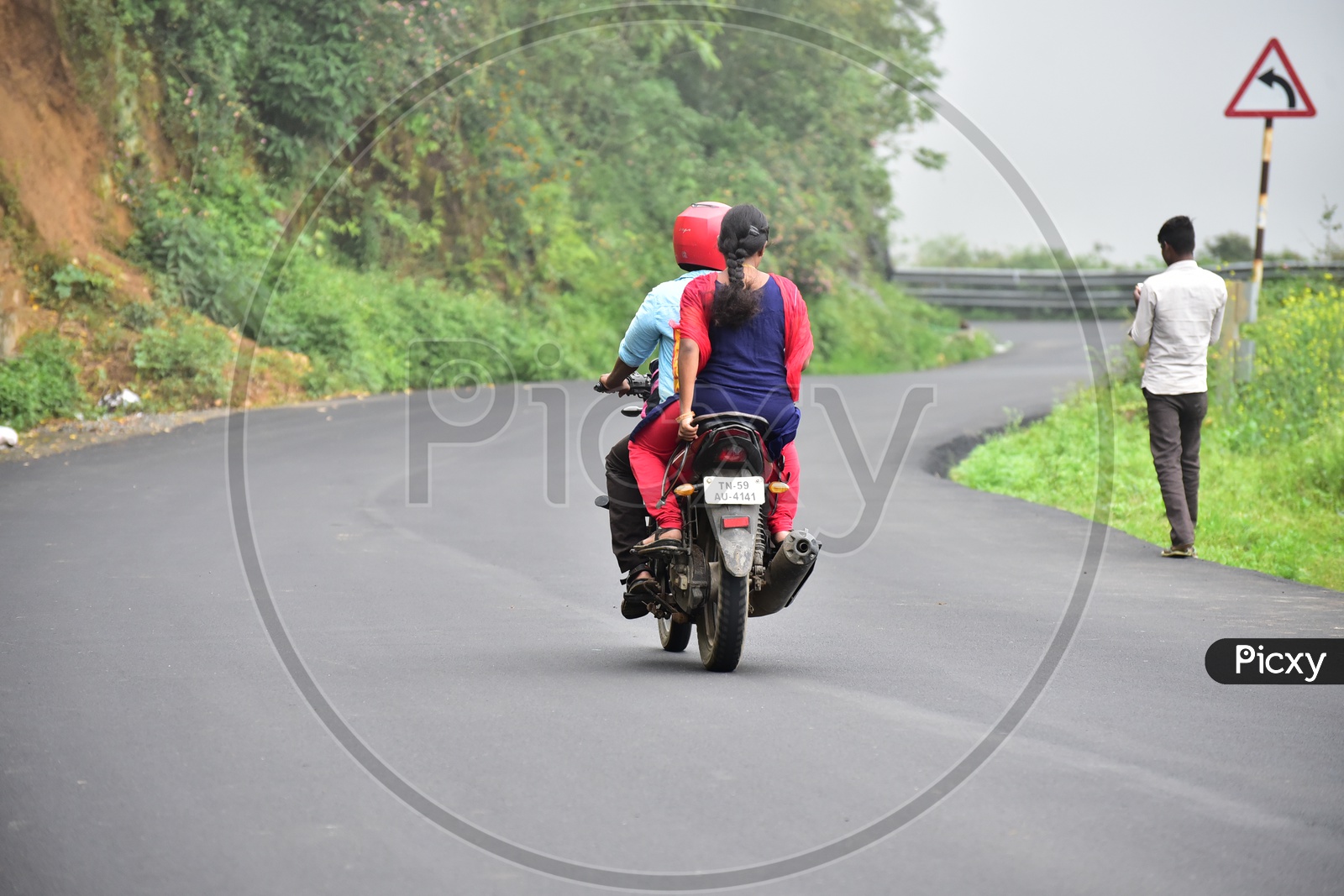 A Couple Travelling On Bike in Munnar Ghat Roads