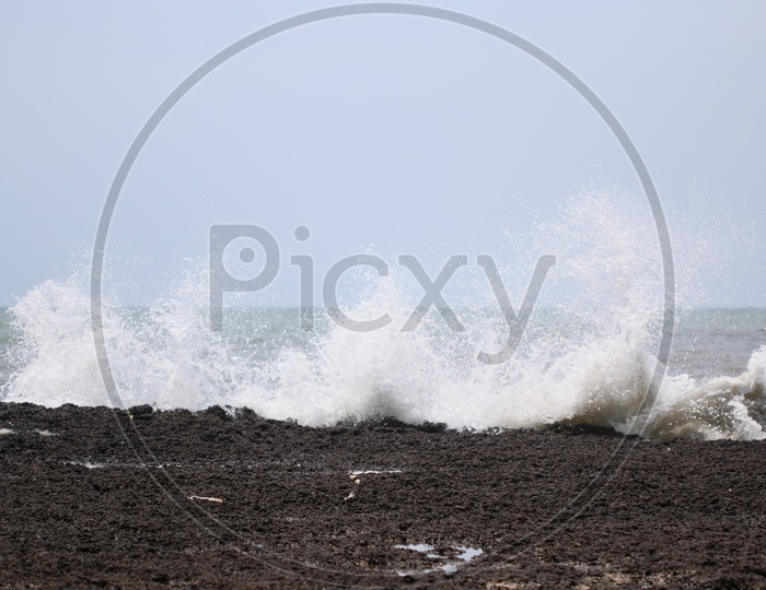 Sea Waves and Black   Stones Composition Shot