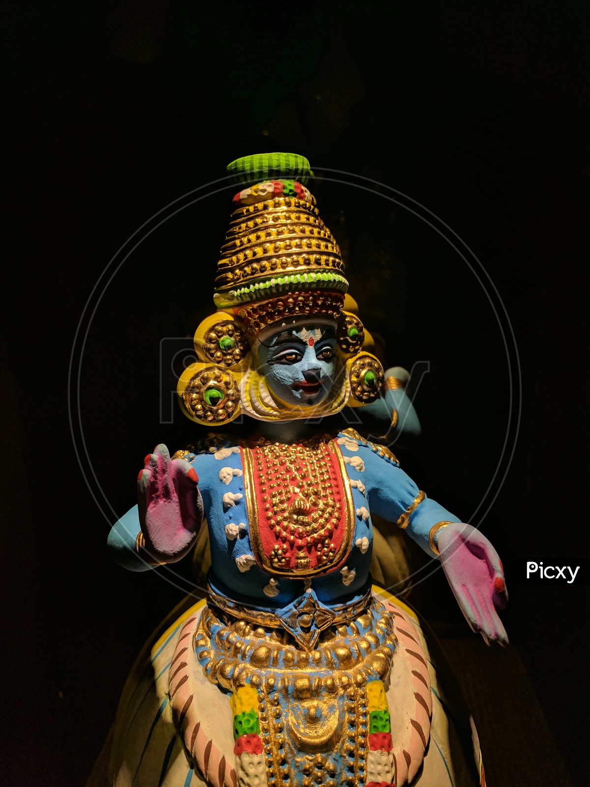 Beautiful Clay Doll of South Indian Dancing Icon with a Black Background