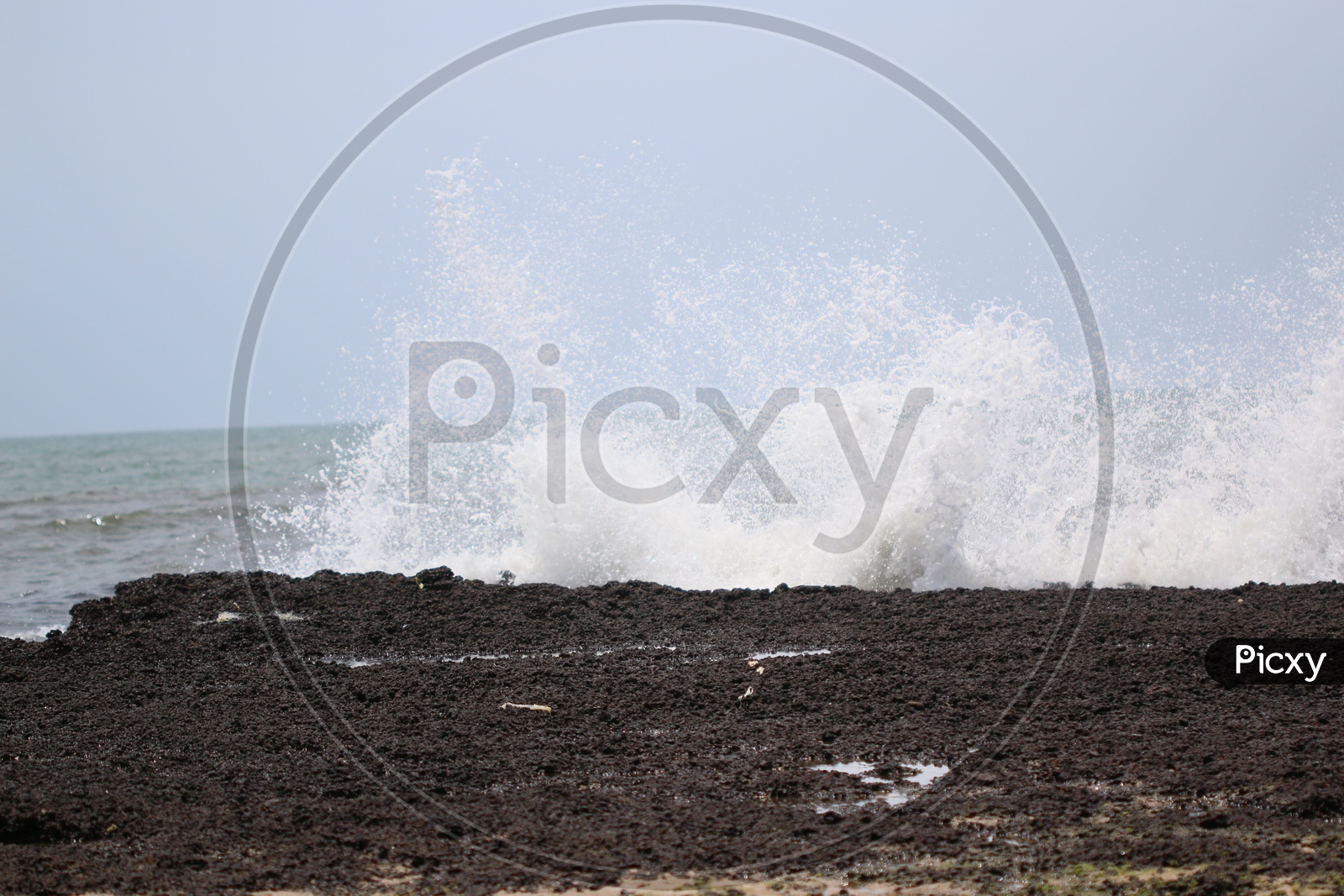 Sea Waves and Black   Stones Composition Shot