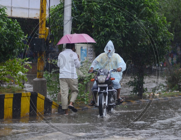 Biker in Water logged street, Cyclone Pedhai, Rain