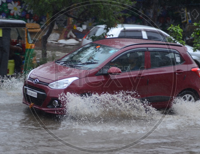 Car in Water logged street, Cyclone Pedhai, Rain