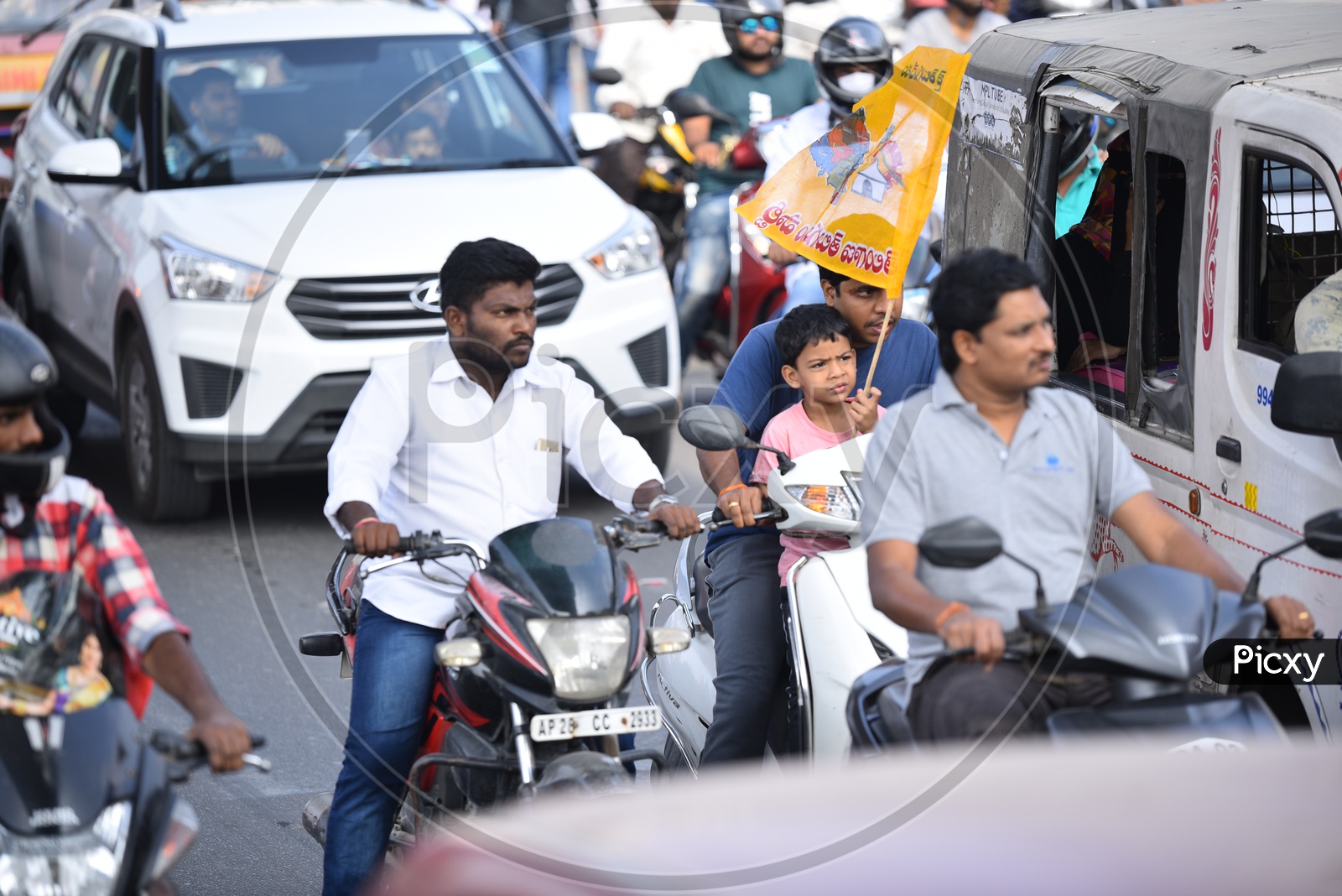 A Child Carrying TDP Flag in a Traffic