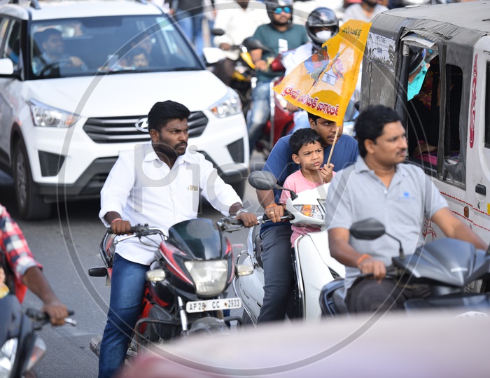A Child Carrying TDP Flag in a Traffic