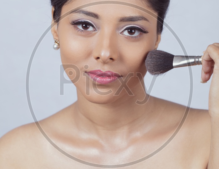 Indian smiling Female Model with Make up Brush