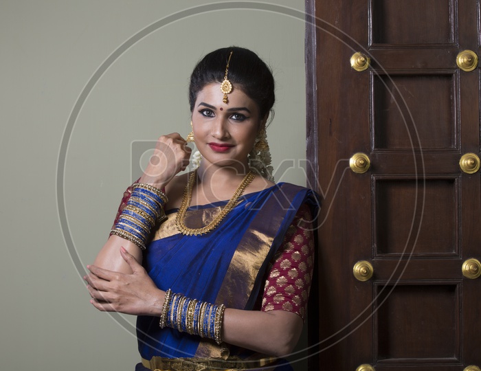 Indian Bride dressed up in blue saree portrait in Studio Lighting