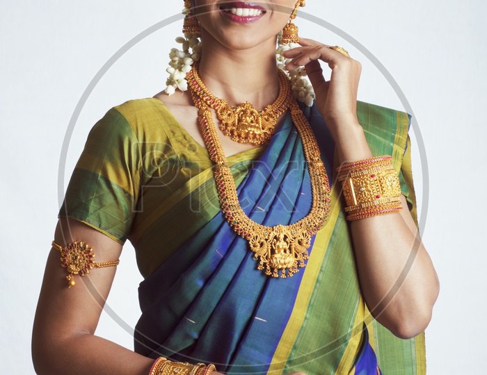 Traditional Indian Female/Woman Model in Blue Saree, green Blouse - Showing her earrings