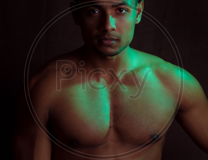 Indian Bodybuilder Male Looking to Camera And Posing on An Isolated Background