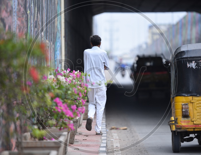 Pedestrian Walking on a Footpath in an Underpass in Hyderabad