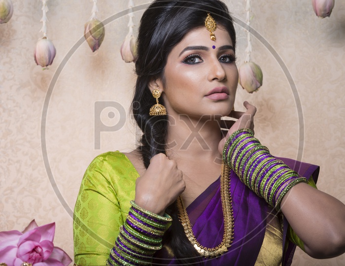 Traditional Indian Female/Woman Model in Purple Saree, green Blouse - Posing