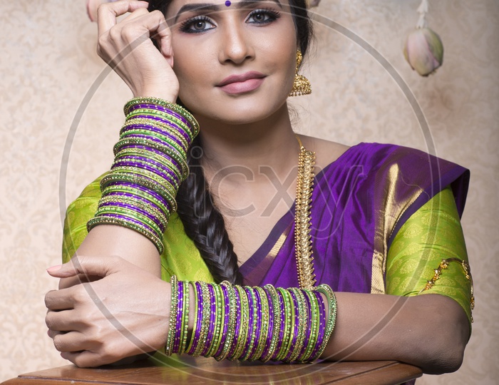 Traditional Indian Female/Woman Model in Purple Saree, green Blouse - Smiling