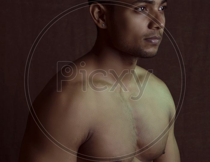 Indian Male Bodybuilder Posing Over an Isolated Background