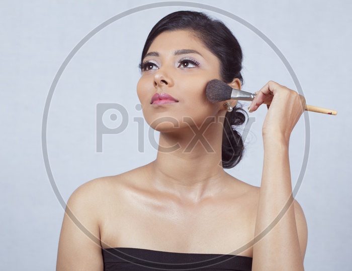 Indian smiling Female Model with Make up Brush
