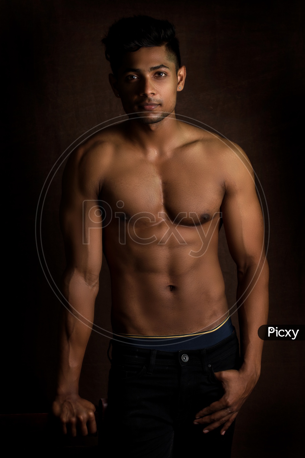 Indian Bodybuilder Male Looking to Camera And Posing on An Isolated Background