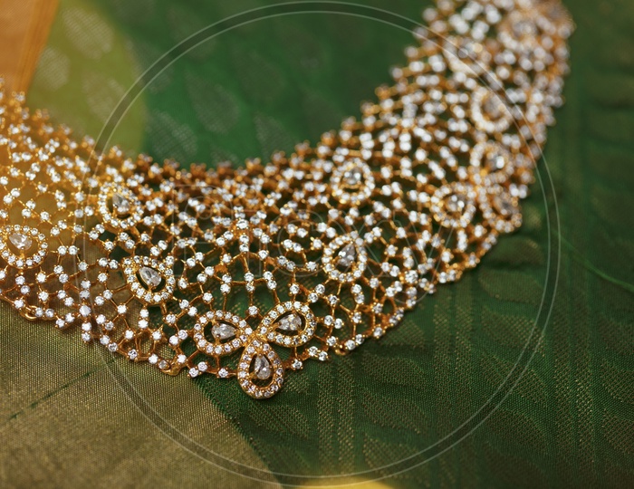 Choker Necklace In Green background - Indian Jewelry/Gold Ornament - Close up