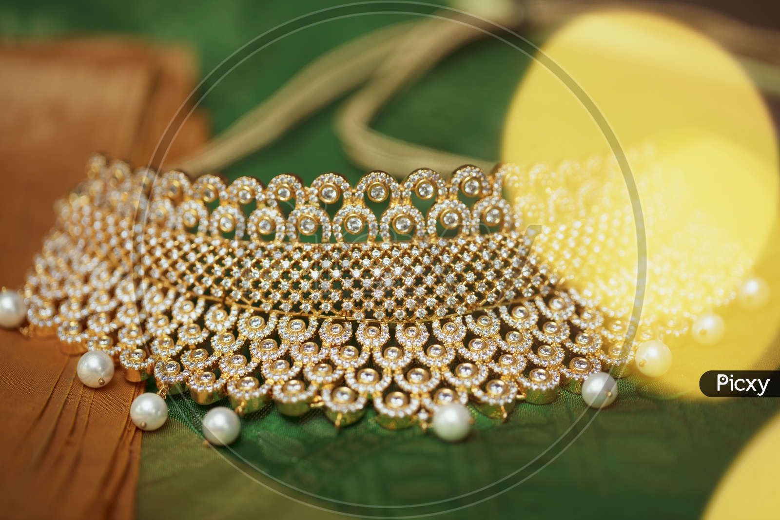 Choker Necklace In Green background - Indian Jewelry/Gold Ornament with White Pearls - Close up