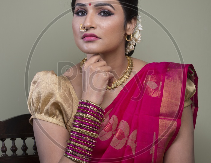 Image of Indian Bride dressed up in red saree portrait in Studio ...