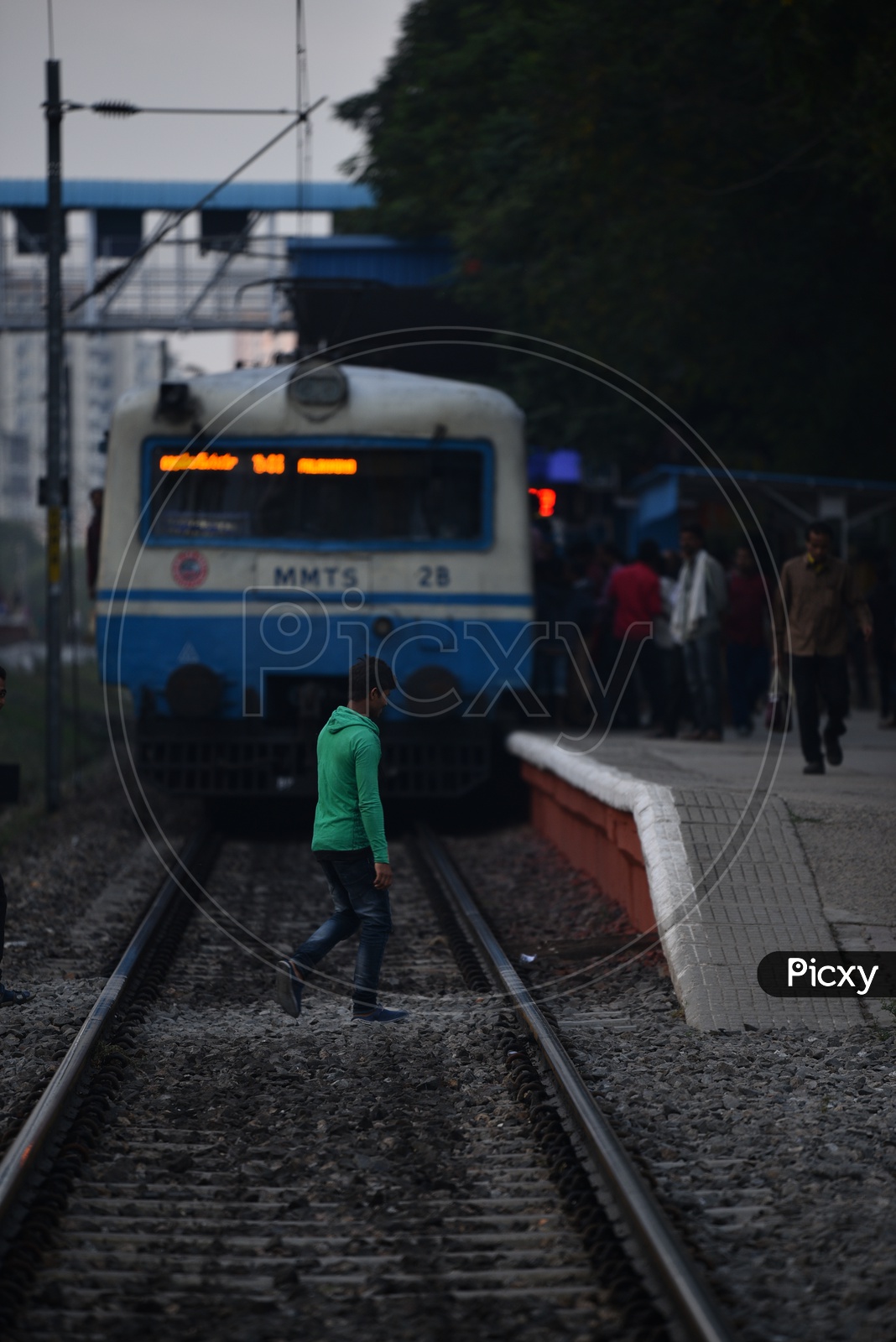 Indian Male Crossing a  Railway track in a MMTS Sattion In Hyderabad