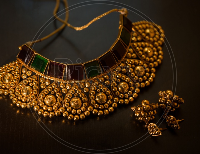 Indian traditional Gold jewelry Necklace and Ear rings Set Closeup Shot