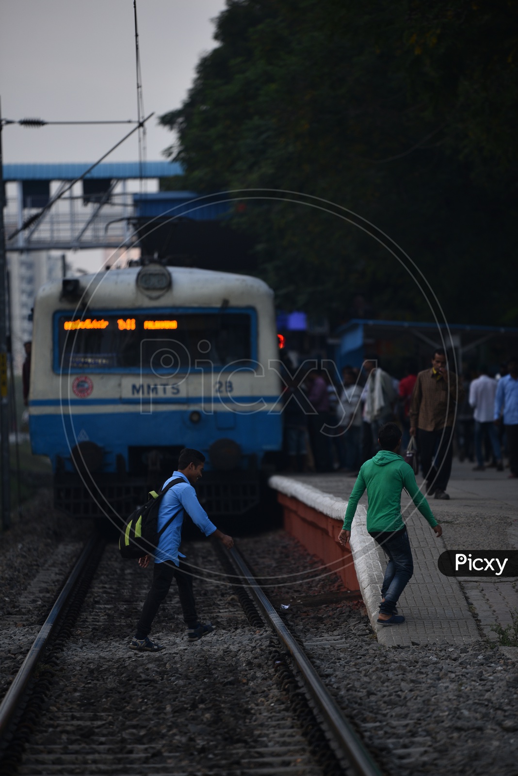 Indian Male Crossing a  Railway track in a MMTS Sattion In Hyderabad