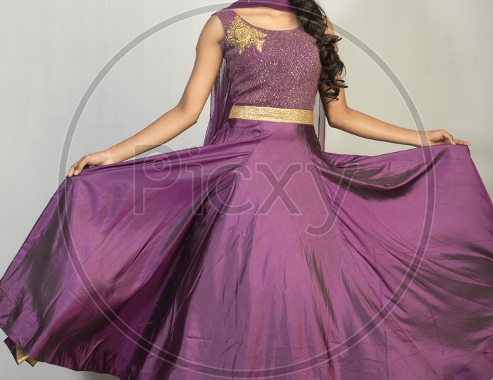Indian girl dressed up in purple dress  portrait in Studio Lighting / Traditionally dressed up girl