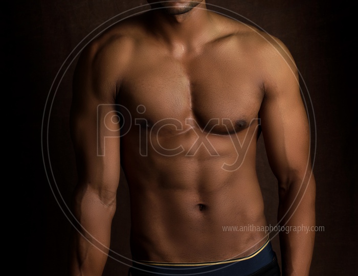 Indian Bodybuilder Male Looking to Camera And Posing on An Isolated Background