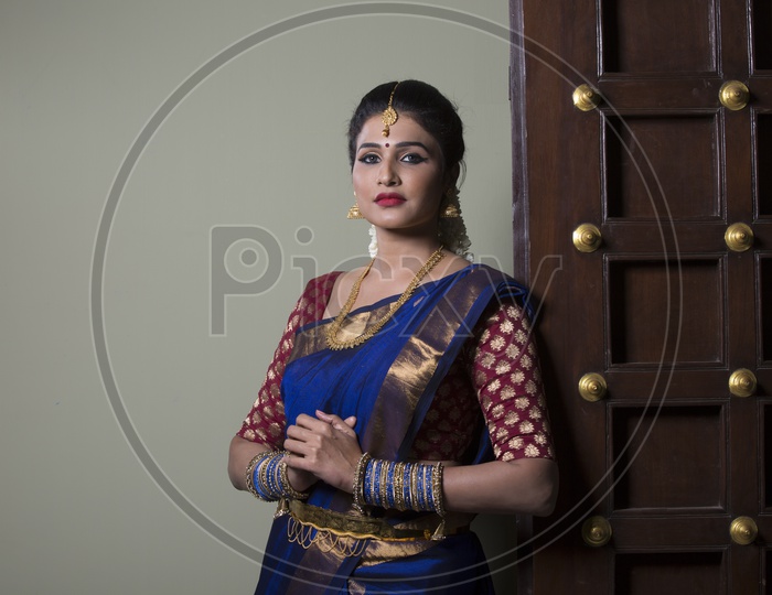 Indian Bride dressed up in blue saree portrait in Studio Lighting