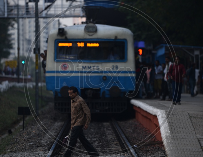 Man crossing railway platform  at Hi-Tech City Railway station