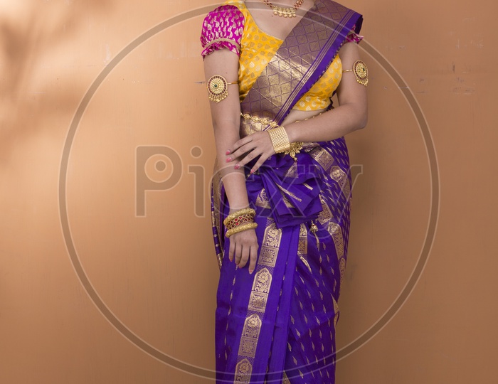 Indian Bride dressed up in purple saree portrait in Studio Lighting / Traditionally dressed up girl